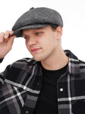 Man wearing grey wool newsboy cap front view plaid jacket winter
