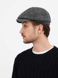 Detail shot grey wool tweed newsboy cap with 8 panels and button top construction