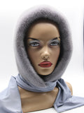 Three-quarter view iris grey mink hood showing cool lavender-grey mink tone and pale coordinated fabric scarf