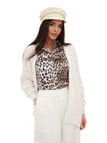Woman wearing ivory cotton fisherman cap and white wide-leg pants