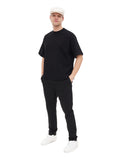 Man wearing ivory cotton flat cap full body front view black outfit