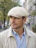 Man wearing ivory linen canvas newsboy cap front view summer outdoor