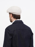 Back view ivory linen newsboy cap showing 8-panel construction