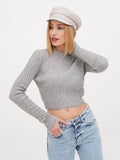 Close-up of woman in ivory linen newsboy cap with grey ribbed top