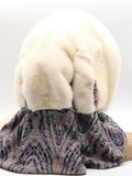 Detail view abstract brown-grey floral print scarf with two ivory mink pompons at ends of ivory fur hat hood