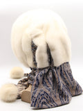 Three-quarter back view ivory mink fur hat hood with abstract floral scarf and two white pompons visible