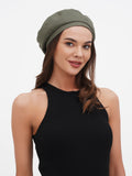 Close-up of khaki linen women's beret showing olive green color and flat crown linen texture detail