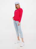 Woman wearing light blue linen Breton cap, red sweater and jeans full length