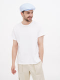 Man in light blue linen newsboy cap full body front standing