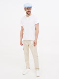 Man in light blue linen newsboy cap full body relaxed pose