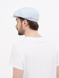 Back view light blue linen newsboy cap showing 8-panel crown