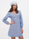 Light blue linen women's beret side glance portrait showing adjustable flat crown beret fit