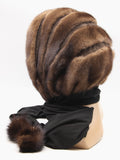 Three-quarter view light brown mink brown suede striped cowl showing warm tonal stripe texture and hood depth