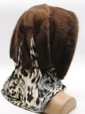 Detail view classic brown-black leopard print scarf of light brown mink fur hat hood showing warm-toned pattern