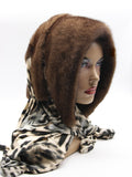 Light brown natural mink fur hat hood with warm classic leopard print scarf on female model, front view