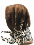 Close view light brown mink fur hat hood showing natural warm tan-brown mink pile texture and clean face opening