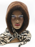 Three-quarter view light brown mink fur hat hood showing warm natural mink surface and leopard print scarf drape
