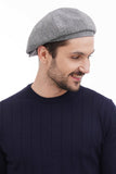 Back view of man wearing light grey 8-panel newsboy cap showing traditional shape full body