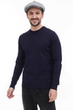 Close-up of man in light grey 8-panel baker boy hat with navy sweater torso side angle