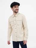 Side view man wearing black slouchy newsboy cap with beige jacket showing fit