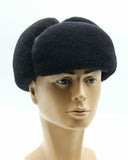 Man wearing black sheepskin ushanka side angle view
