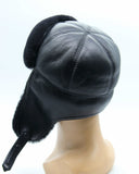 Man wearing black ushanka earflaps up side profile