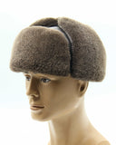 Man wearing brown ushanka earflaps down side view