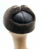Man wearing brown visor cap back view earflaps down