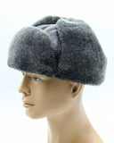 Man wearing grey ushanka earflaps tied back