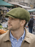Man in olive corduroy baker boy hat outdoor casual