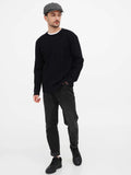 Man wearing grey wool newsboy cap front view with black sweater casual style