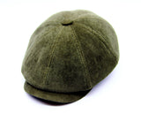 Man wearing olive velvet newsboy cap outdoor street