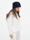 Side view of navy blue cloche hat showing stone flower detail