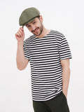 Man wearing olive wrinkled linen newsboy cap with striped shirt touching visor front view