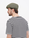 Side profile olive wrinkled linen newsboy cap showing visor angle and crown shape