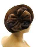 Pastel brown mink beret with mink flower three-quarter left view showing warm caramel fur and tonal flower position