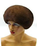 Pastel brown mink beret with fur flower right profile showing caramel fur sheen and dome crown shape