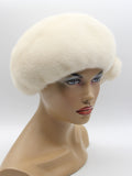 Pearl beige mink beret with fur bow three-quarter left view showing warm cream fur tone and bow position