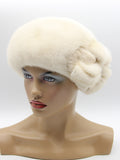 Pearl beige mink beret right side profile showing natural cream fur sheen and structured mink bow