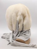 Back view pearl mink fur hat hood on mannequin showing full cream-beige mink coverage and grey scarf