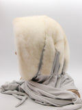 Side profile pearl mink fur hat hood scarf on mannequin showing suede strip at hood-scarf join