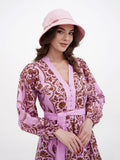 Side profile of pink cotton bucket cloche showing brim and belt
