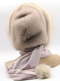 Close front view powder pink fox fur trim fanning around face opening of mink hood wrap