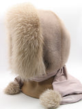Powder pink mink fur hood scarf wrap with toned fox trim and pompons on mannequin, side three-quarter view