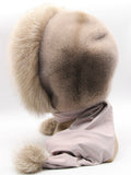 Side profile powder pink fur hood scarf wrap on mannequin showing scarf length and fox pompon