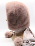 Side profile powder pink mink fur hood scarf showing hood depth and mink pompon at scarf end