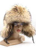 Raccoon fur hat for women with golden fur and long ear flaps down, front three-quarter view