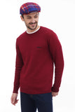 Side profile man in red blue plaid flat cap with burgundy sweater casual smil