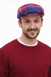 Torso front view man in red blue checkered flat cap with burgundy sweater casual smile
