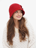 Woman in red cloche hat and cream sweater, front view
